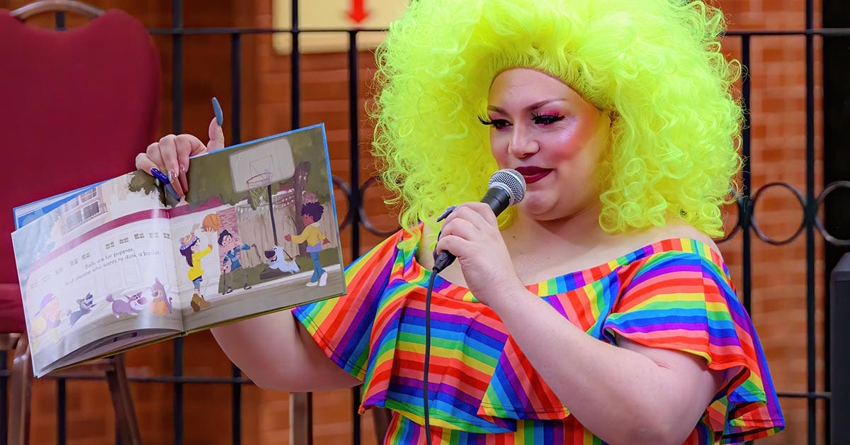 A drag queen reads from a children's book