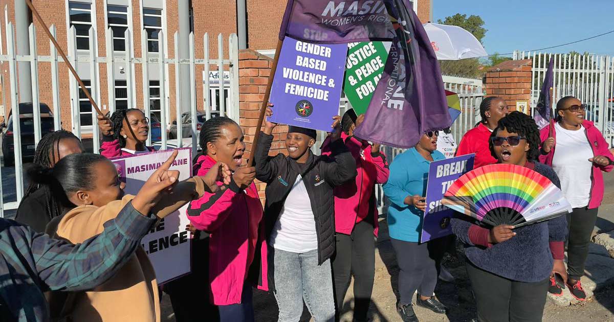A photo of several activists singing outside the East London High Court on Monday in protest against queerphobic shop owner Dawood Lagardien.